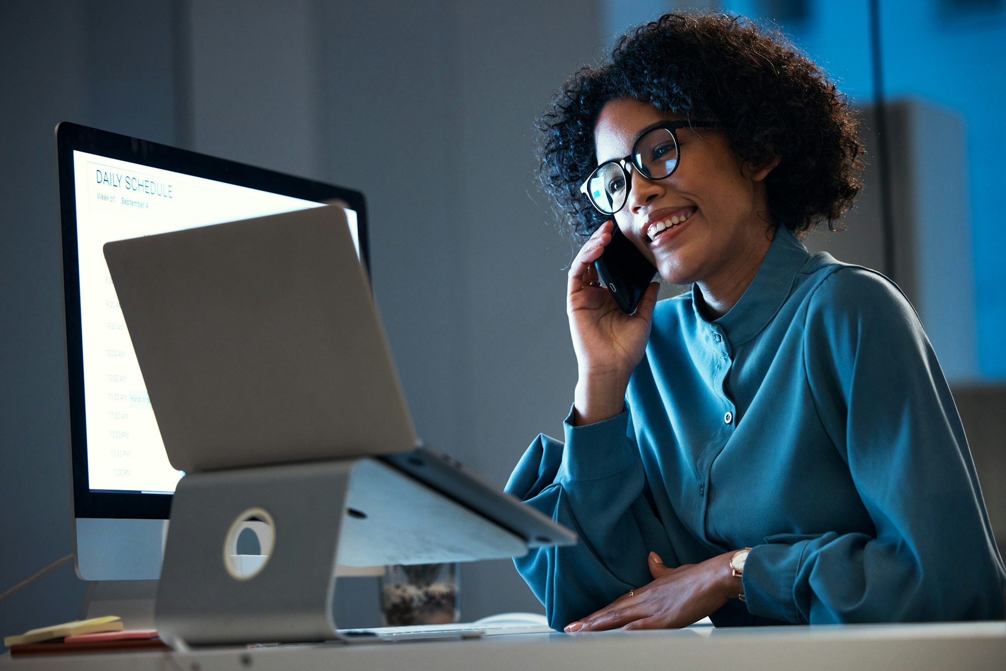 Laptop, phone call discussion and professional happy woman consulting on report data, web traffic o